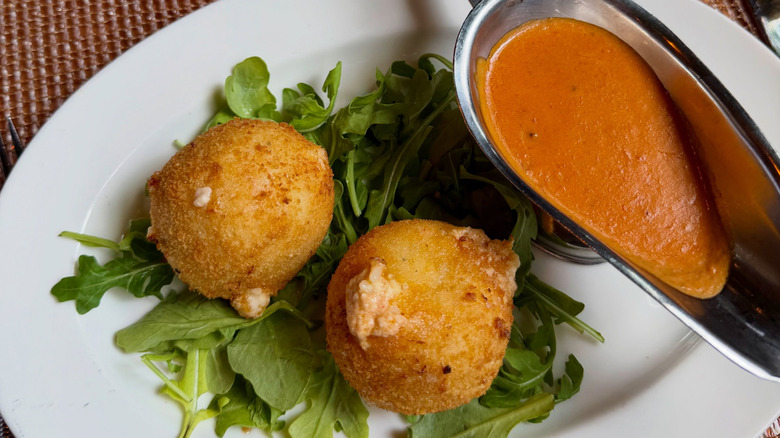 Two lobster arancini balls with tomato sauce at Filomena Ristorante
