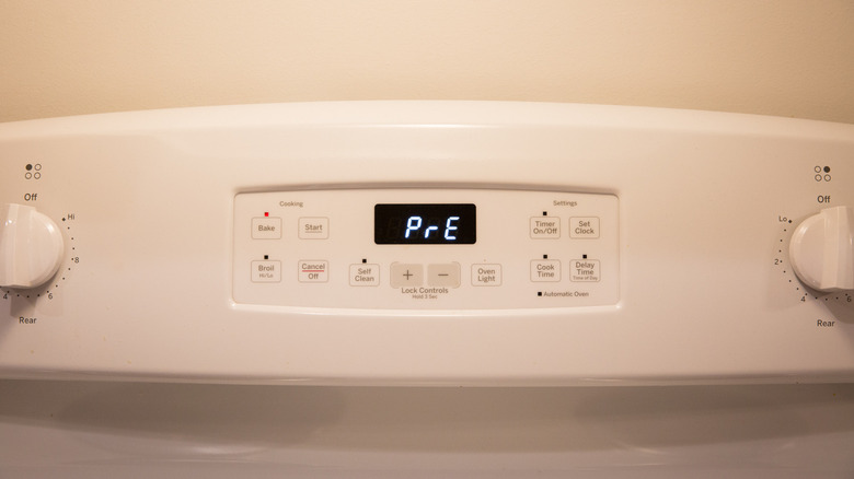 closeup of oven display showing preheat symbol