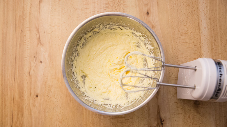 cookie batter in mixing bowl next to used electric mixer