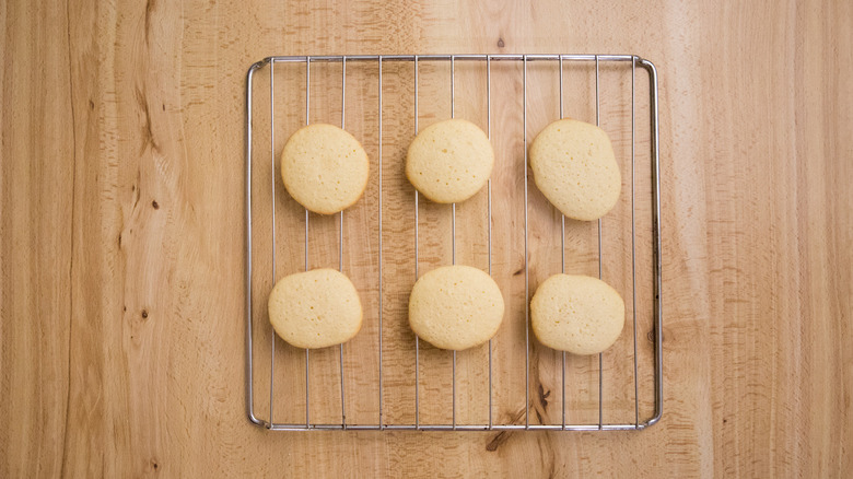plaiin lemon cookies on cooling rack over wooden surface