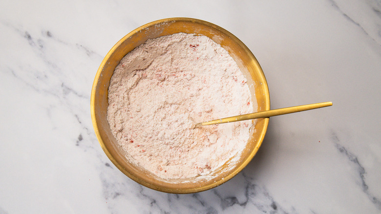 Dry ingredients in bowl with fork.