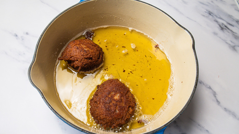 Frying donuts in oil.