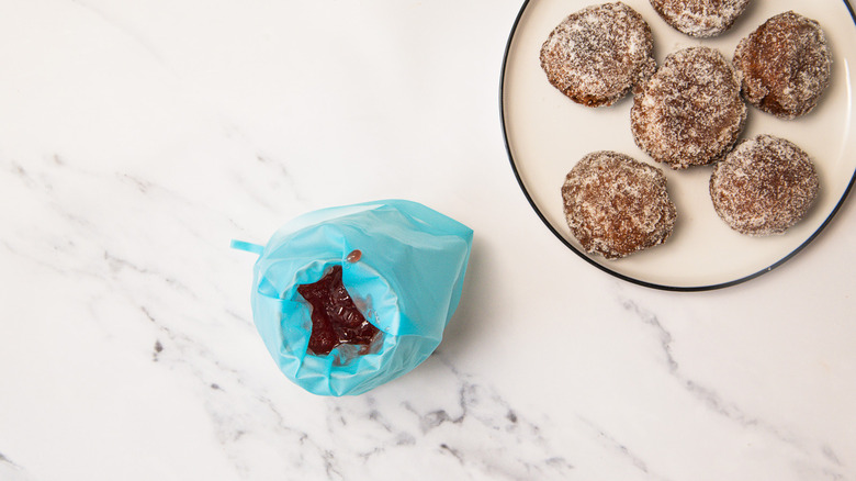 Pastry bag filled with strawberry jam.