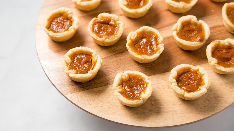 mini pumpkin pies on board