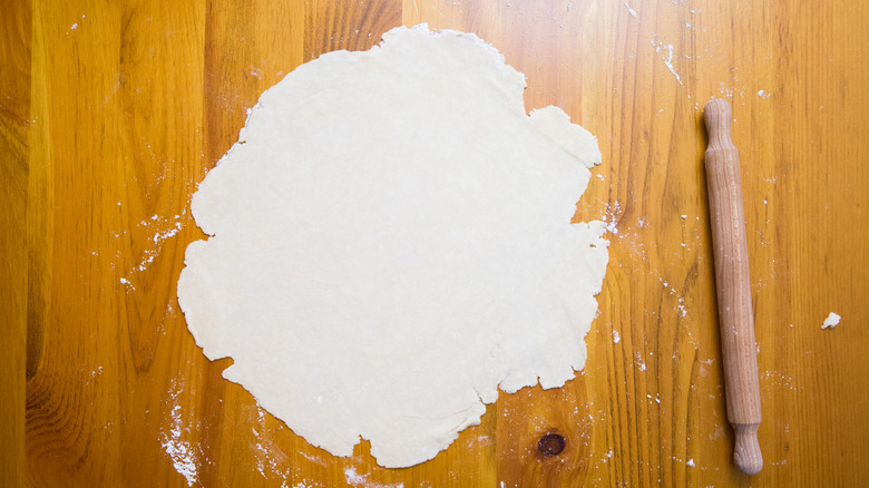 rolled dough on wooden table