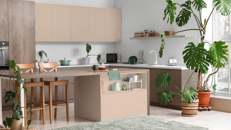 Minimalist kitchen with beige cabinets and wood island