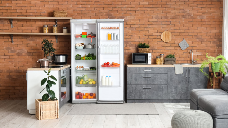 Kitchen with brown exposed brick wall and gray slate cabinets