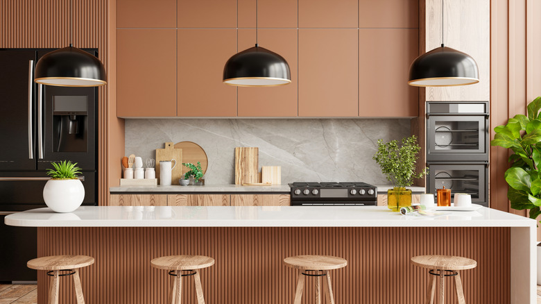 Modern kitchen with terra cotta, black, and white color scheme