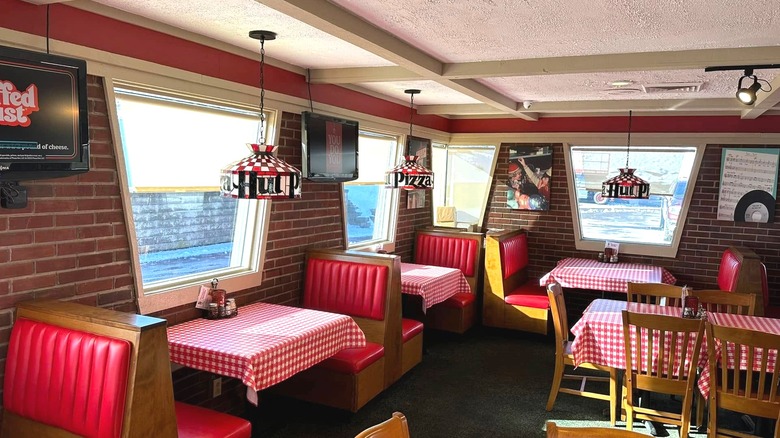 Interior of Pizza Hut Classic restaurant featuring booth and table seating