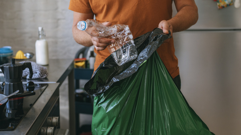 A person with a large trash bag