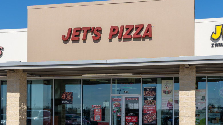 Red Jet's Pizza sign on beige building
