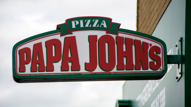 Papa John's pizza sign affixed to building