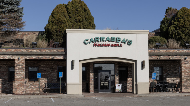 Outside view of Carrabba's Italian Grill with trees and plants growing on roof
