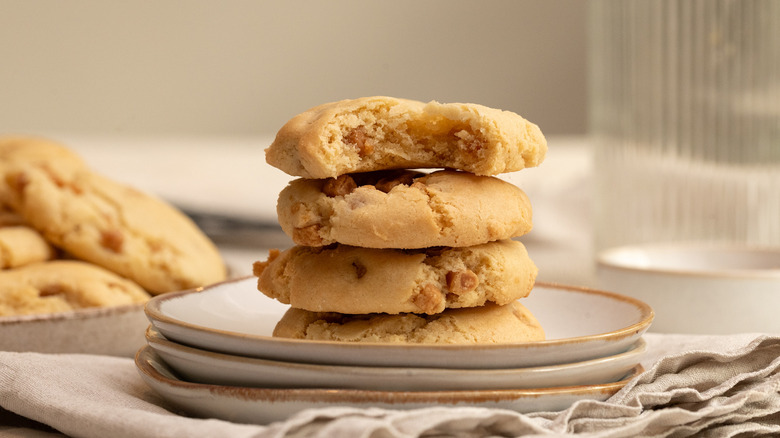 four easy soft caramel cookies stacked on stacked plates