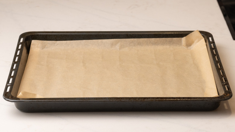 parchment paper lined baking sheet on white surface