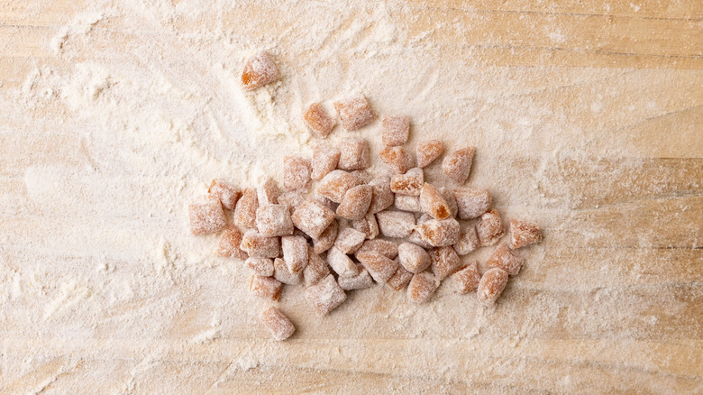 soft caramel pieces dusted with flour on a floured wooden surface