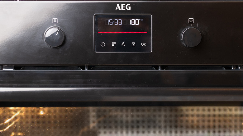 closeup of an oven preheating with time and temperature settings
