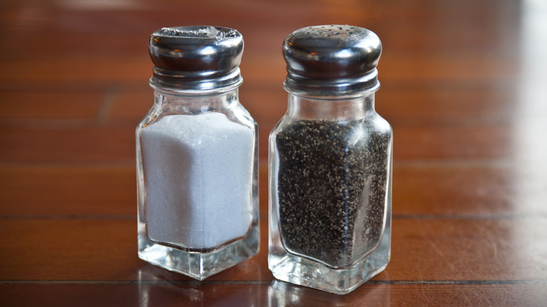Salt and pepper shakers on wood table