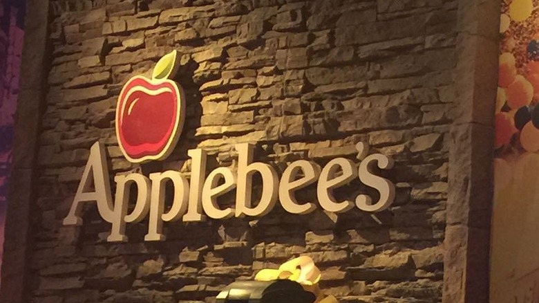 Applebee's sign on a wall inside an Applebee's restaurant.
