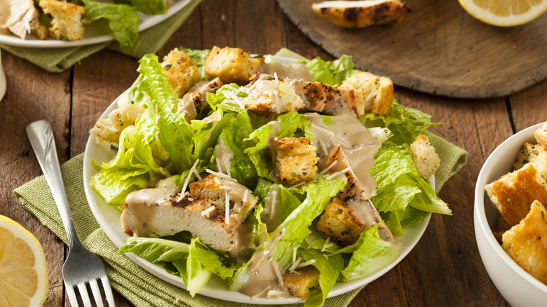 Chicken Caesar salad on wooden table