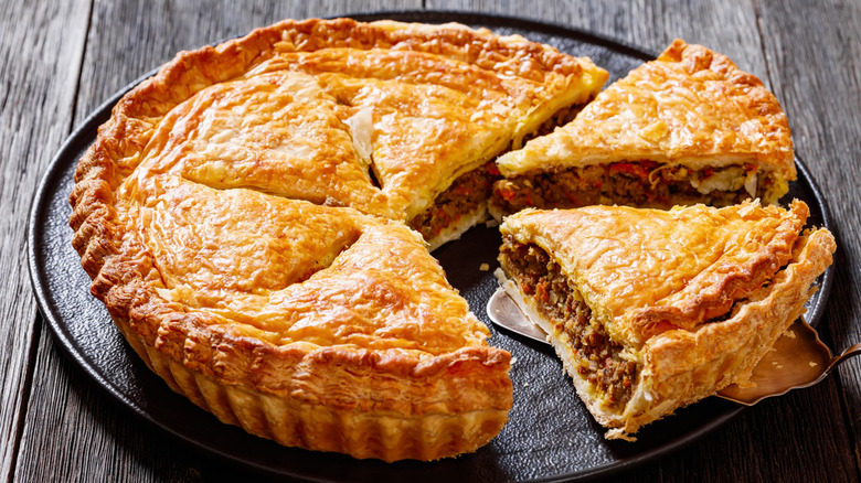 Sliced meat pie on gray plate