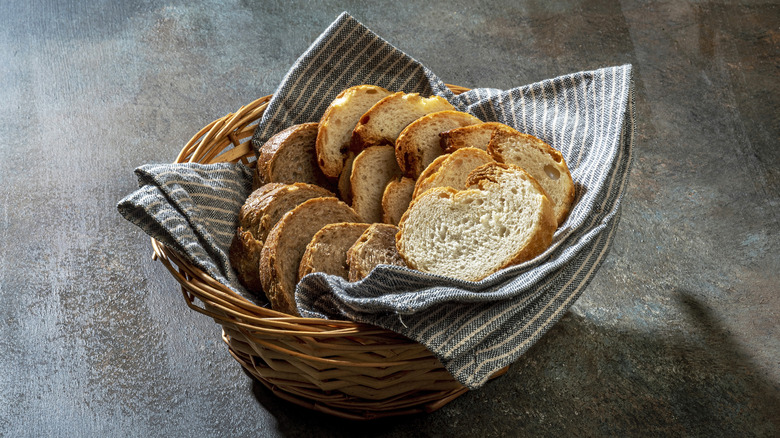 Bread slices in basket with blue cloth