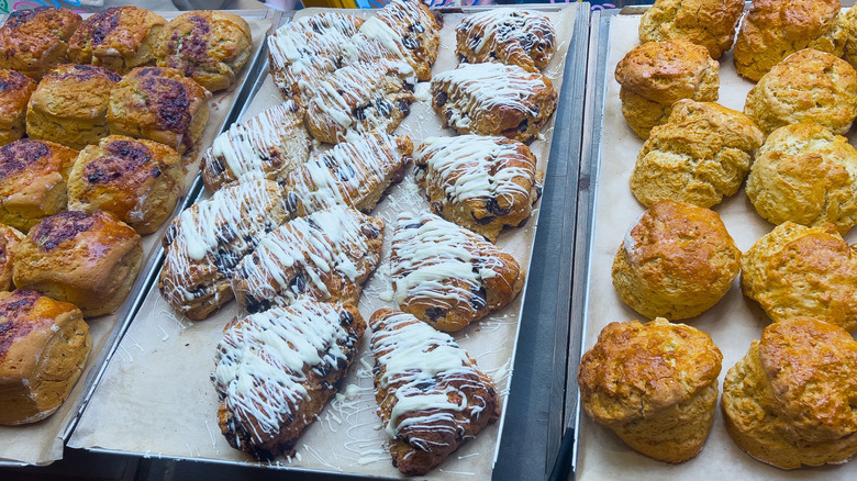 Multiple trays of different types of scones