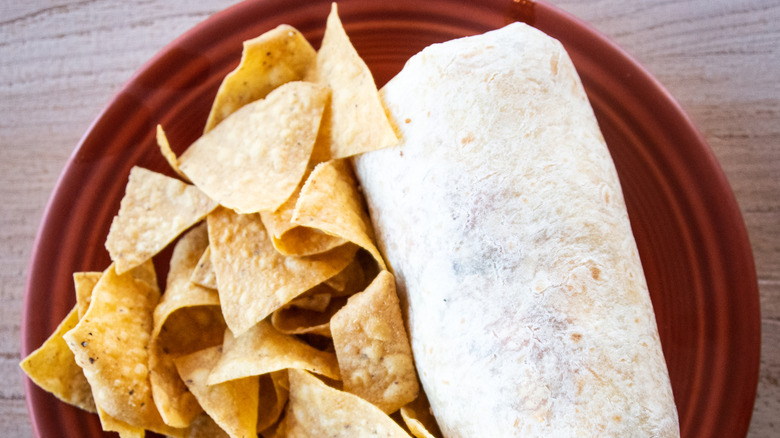Top-view of a Mexican burrito and tortilla chips