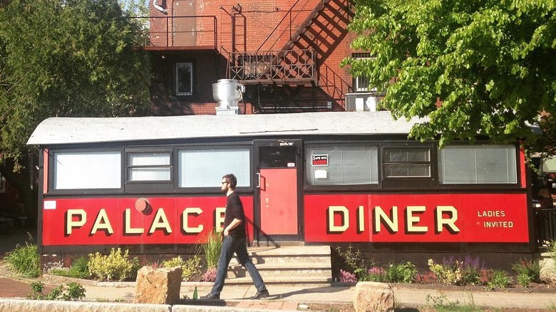 A man walks past the Palace Diner