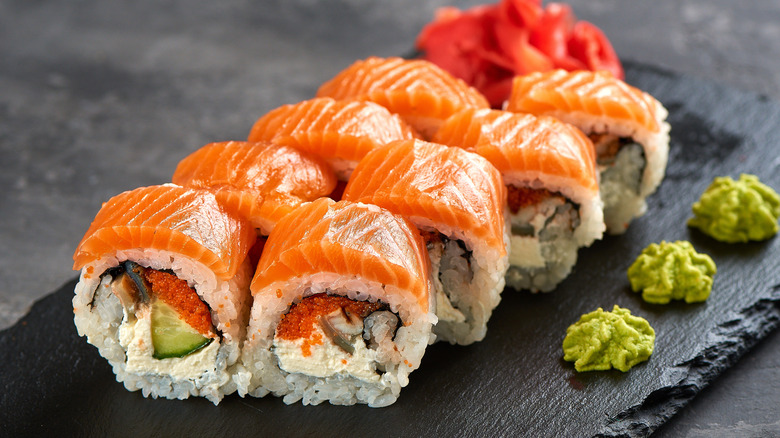 a California sushi roll on a platter with ginger and wasabi