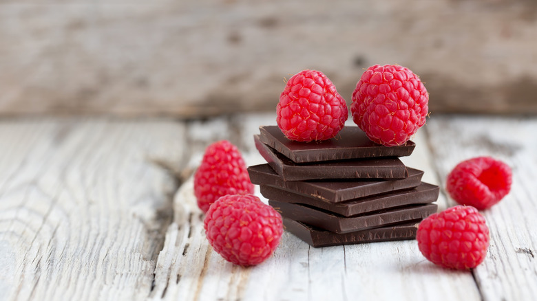 Squares of dark chocolate with fresh raspberries
