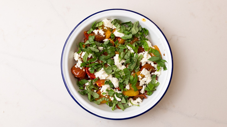 assembling heirloom tomato salad