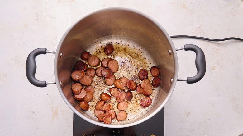browning sausage in a pot