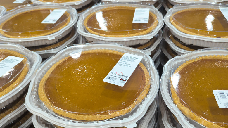 Costco brand Kirkland Signature pumpkin pies stacked in a store display
