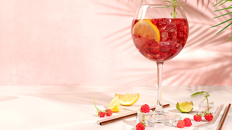 Spritz cocktail in stemmed glass with raspberries