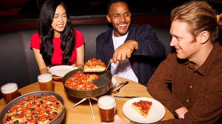 people eating deep dish pizza
