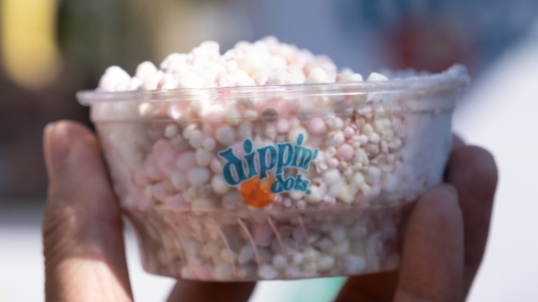 Hand holding cup of Dippin Dots