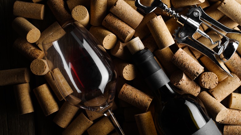 Wine glass, bottle, and cork screw on corks