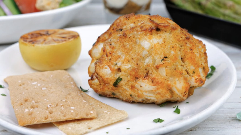 Crab cJimmy's Famous Seafood crab cake on a plate with garnish