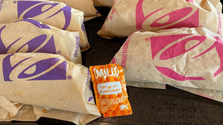 Taco Bell tacos wrapped in paper on a tray