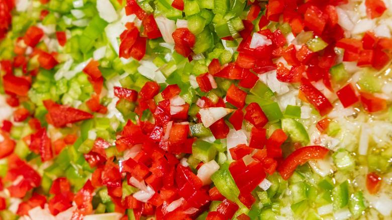 Close-up of diced red and green peppers with white onion.