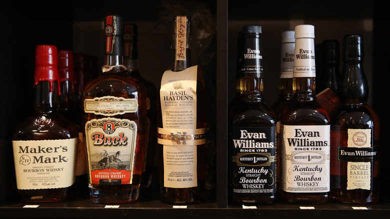 Various bottles of branded bourbon in a row