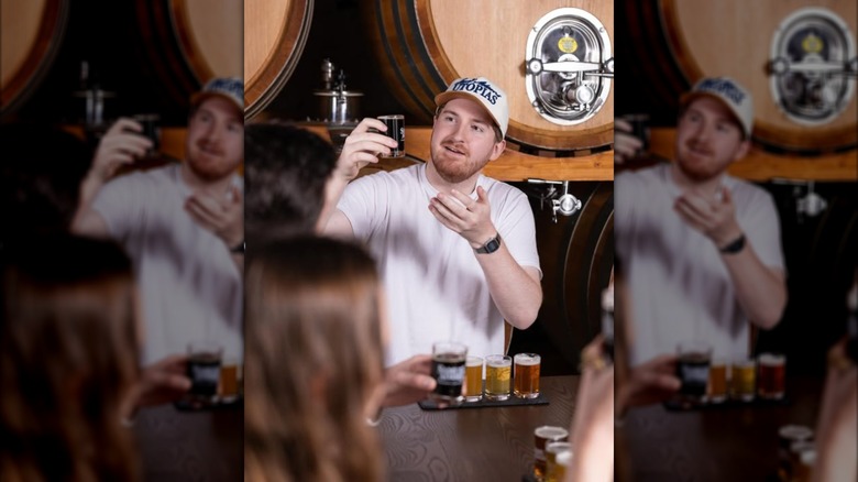 Employee showing beer flight in brewery