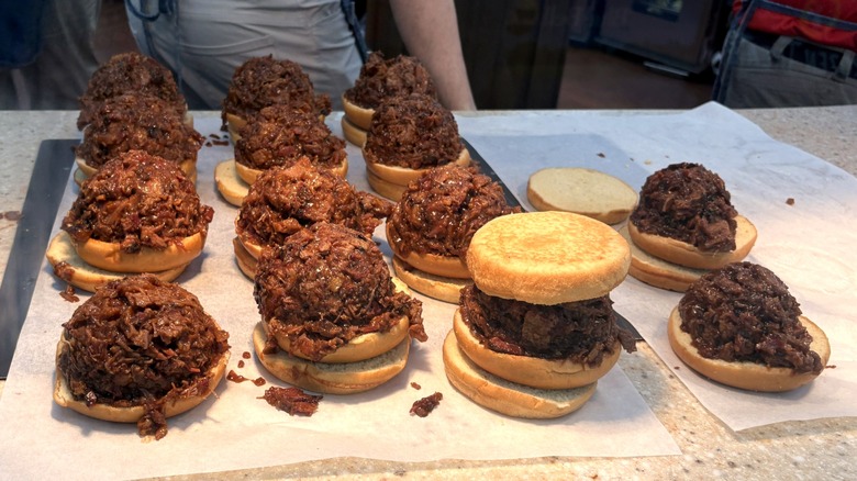 Chopped brisket meat and sandwich buns sitting on counter inside Buc-ee's gas station