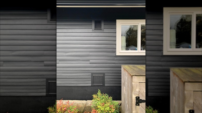 Outside of an old California home with vent for kitchen cabient