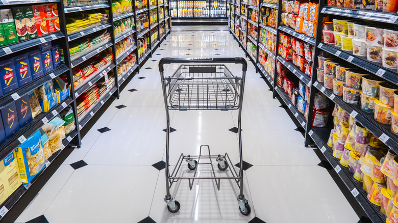 Shopping cart in grocery store pasta aisle