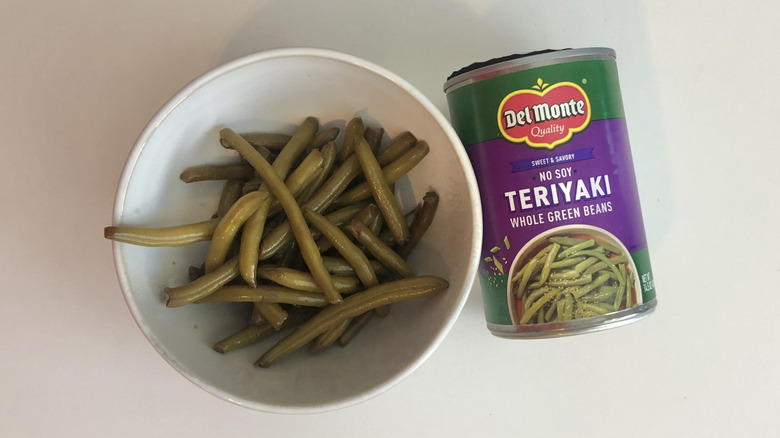 Bowl of Del Monte teriyaki green beans beside the empty can
