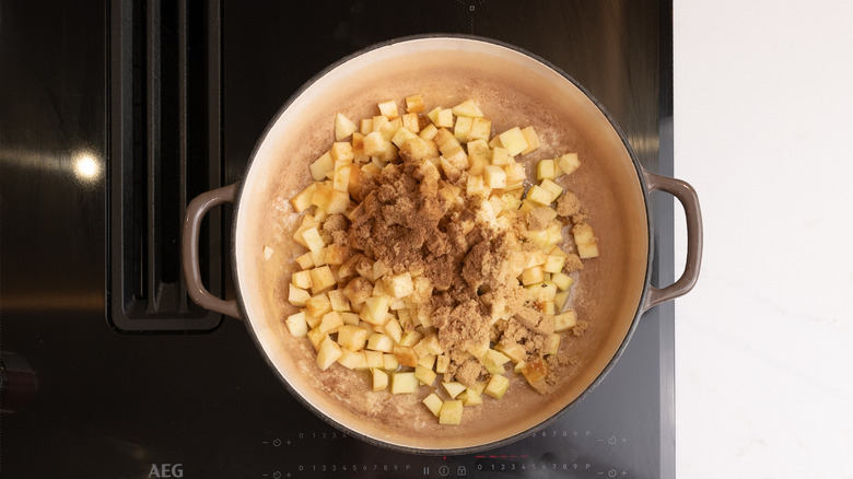 Diced apples and spices inside of pan