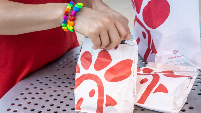 Person holding chick-fil-a takeout bags