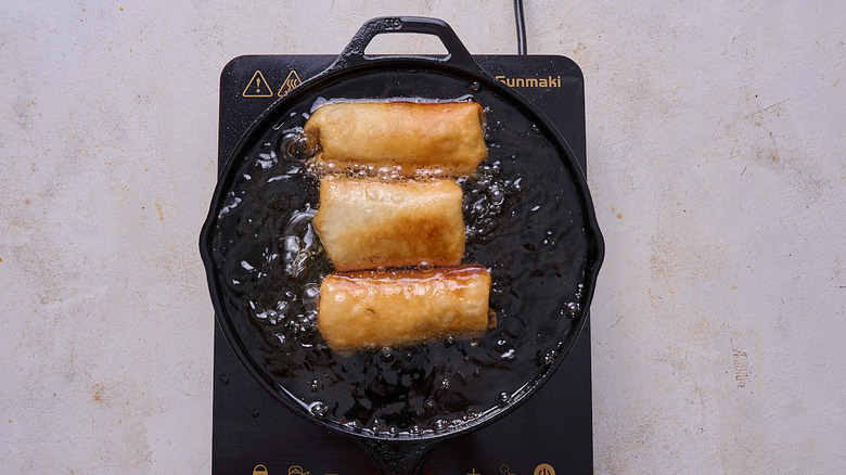 frying chimichangas in skillet